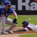 
              Chicago White Sox's Luis Robert, right, steals second base as Texas Rangers second baseman Marcus Semien tries to catch the ball during the first inning of a baseball game in Chicago, Sunday, June 12, 2022. (AP Photo/Nam Y. Huh)
            
