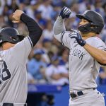 
              New York Yankees' Anthony Rizzo (48), and Giancarlo Stanton (27) celebrate after Stanton homered against the Toronto Blue Jays during the fifth inning of a baseball game Friday, June 17, 2022, in Toronto. (Christopher Katsarov/The Canadian Press via AP)
            