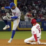 
              Los Angeles Angels' Anthony Rendon, right, is forced out at second on a hit by Brandon Marsh as New York Mets shortstop Francisco Lindor jumps over him during the fifth inning of a baseball game Friday, June 10, 2022, in Anaheim, Calif. (AP Photo/Mark J. Terrill)
            