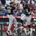 
              Chicago White Sox's Josh Harrison, right, celebrates his two-run home run against the Los Angeles Angels with third base coach Joe McEwing during the fifth inning of a baseball game Tuesday, June 28, 2022, in Anaheim, Calif. (AP Photo/Jae C. Hong)
            