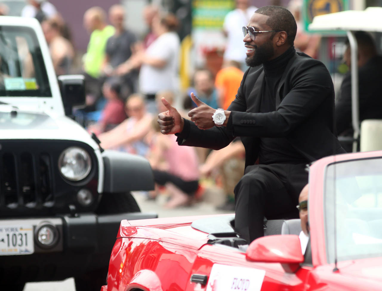 International Boxing Hall of Fame class of 2021 inductee Floyd Mayweather waves to paradegoers duri...
