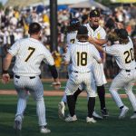 
              Southern Miss pitcher Tyler Stuart is embraced by his teammates as Southern Miss defeated LSU after an NCAA college baseball tournament regional game, Monday, June 6, 2022 in Hattiesburg, Miss. (Hannah Ruhoff/The Sun Herald via AP)
            