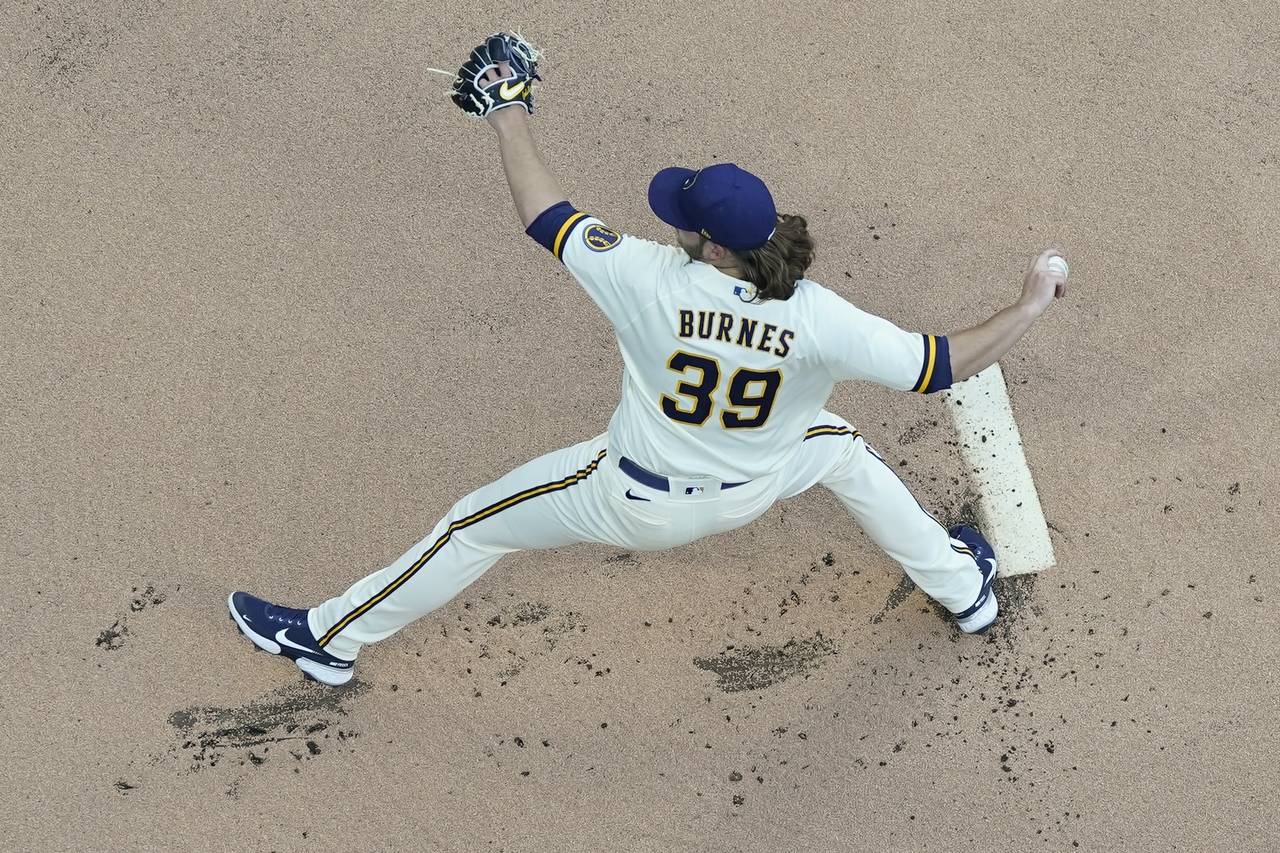 Milwaukee Brewers starting pitcher Corbin Burnes throws during the first inning of a baseball game ...