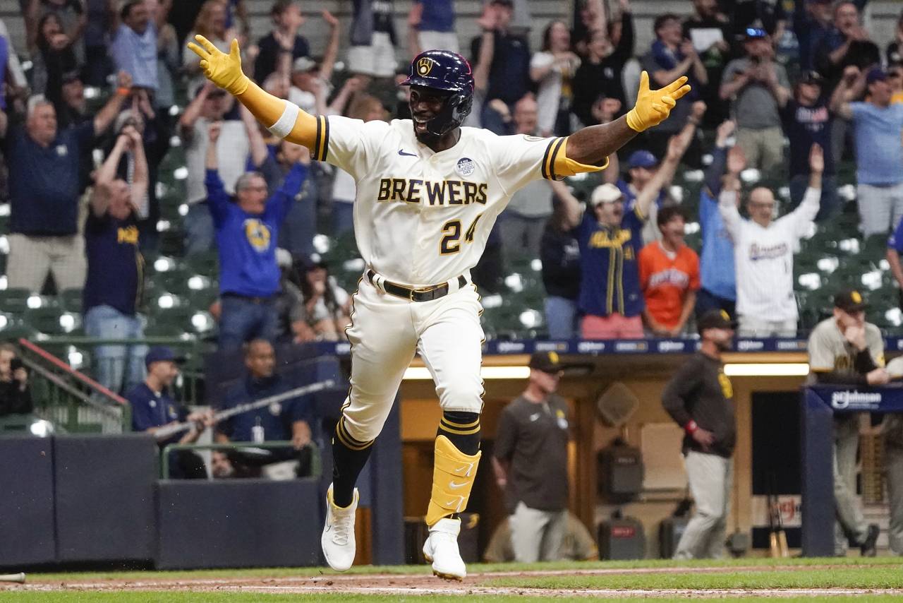 Milwaukee Brewers' Andrew McCutchen celebrates after hitting a walk-off RBI single during the ninth...