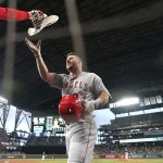 
              Los Angeles Angels' Mike Trout reaches for a cowboy hat as he walks to the dugout after hitting a solo home run against the Seattle Mariners during the third inning of the second baseball game of a doubleheader Saturday, June 18, 2022, in Seattle. (AP Photo/Ted S. Warren)
            