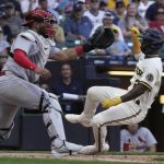 
              Milwaukee Brewers' Andrew McCutchen scores past St. Louis Cardinals catcher Ivan Herrera during the ninth inning of a baseball game Thursday, June 23, 2022, in Milwaukee. McCutchen scored from third on a sacrifice fly by Jace Peterson. (AP Photo/Morry Gash)
            