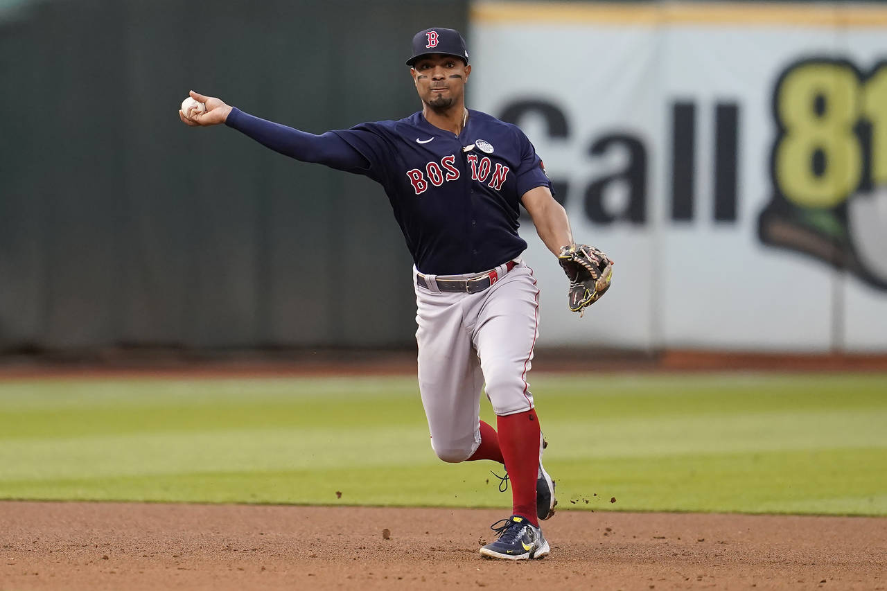 Boston Red Sox shortstop Xander Bogaerts throws out Oakland Athletics' Chad Pinder at first base du...
