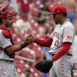 
              Cincinnati Reds relief pitcher Alexis Diaz (43) and catcher Aramis Garcia celebrate a 7-6 victory over the St. Louis Cardinals following a baseball game Sunday, June 12, 2022, in St. Louis. (AP Photo/Jeff Roberson)
            