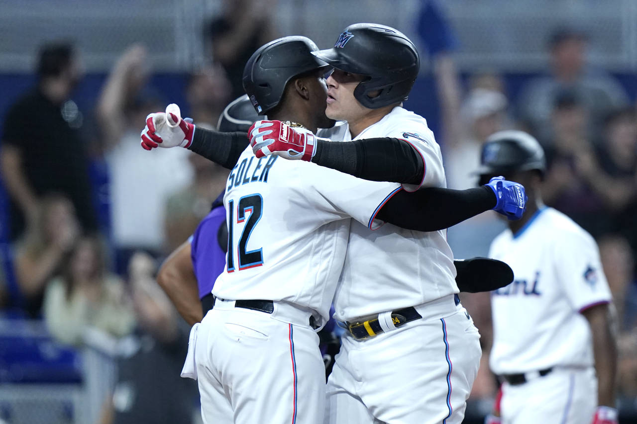 Miami Marlins right fielder Avisail Garcia, right, is met at the plate by Jorge Soler after hitting...