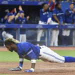 
              Toronto Blue Jays' Ramiel Tapia does pushups at home plate after scoring on a triple by teammate Cavan Bioggio in the fifth inning of a baseball game against the Baltimore Orioles in Toronto, Monday, June 13, 2022. (Jon Blacker/The Canadian Press via AP)
            