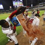 
              Atlanta Braves Guillermo Heredia, from left, and Orlando Arcia dunk outfielder Adam Duvall after he hit a walk-off RBI single to beat the San Francisco Giants after the ninth inning of a baseball game, Wednesday, June 22, 2022, in Atlanta. (Curtis Compton/Atlanta Journal-Constitution via AP)
            