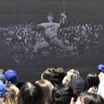 
              Fans watch a video of Sandy Koufax as the Los Angeles Dodgers unveil a Sandy Koufax statue in the Centerfield Plaza to honor the Hall of Famer and three-time Cy Young Award winner prior to a baseball game between the Cleveland Guardians and the Dodgers at Dodger Stadium in Los Angeles, Saturday, June 18, 2022. (Keith Birmingham/The Orange County Register via AP)
            