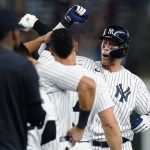
              New York Yankees' Aaron Judge celebrates with teammates after hitting a single to drive in the winning run during the ninth inning of the team's baseball game against the Houston Astros on Thursday, June 23, 2022, in New York. The Yankees won 7-6. (AP Photo/Frank Franklin II)
            