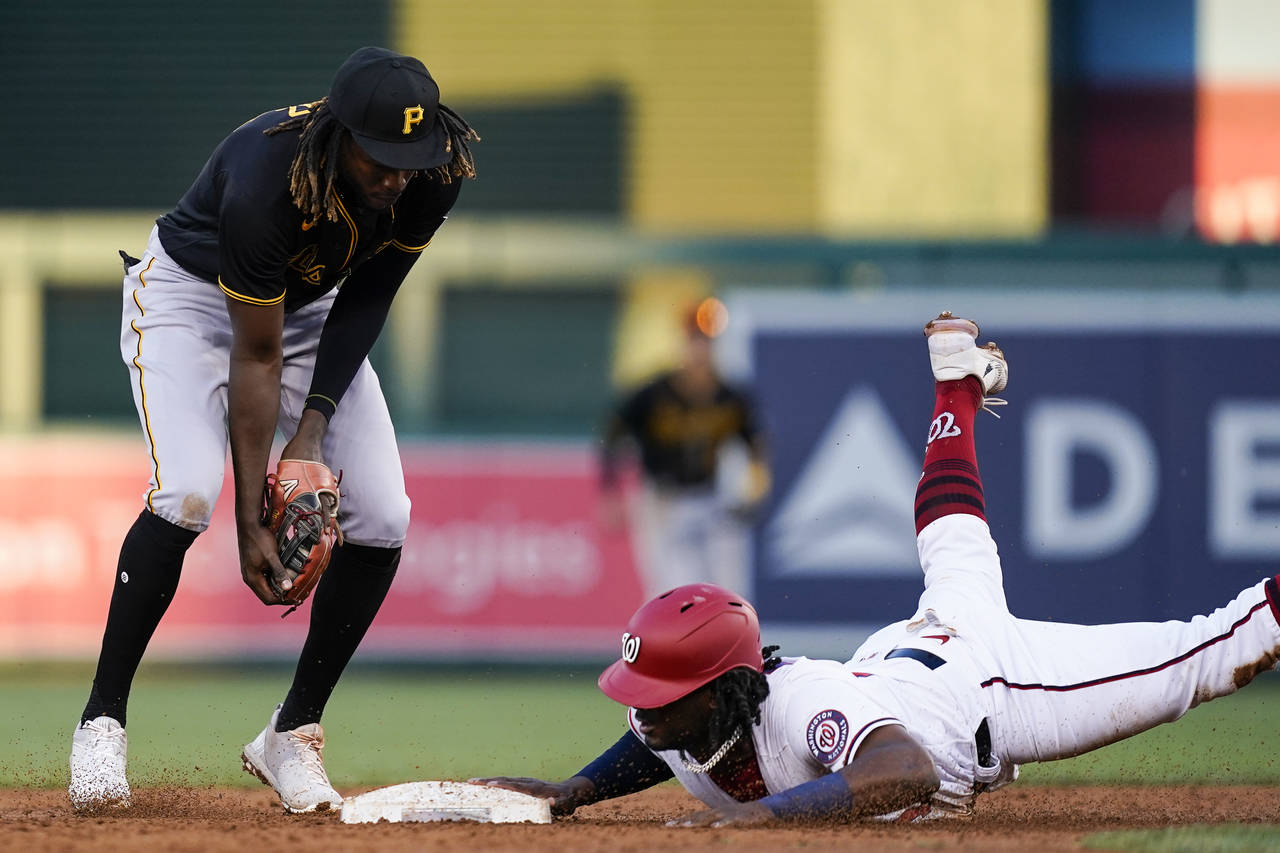 Washington Nationals' Josh Bell, right, is forced out at second base by Pittsburgh Pirates shortsto...