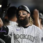 
              Colorado Rockies' Charlie Blackmon is congratulated as he returns to the dugout after hitting a two-run home run off Cleveland Guardians starting pitcher Shane Bieber during the seventh inning of a baseball game Tuesday, June 14, 2022, in Denver. (AP Photo/David Zalubowski)
            