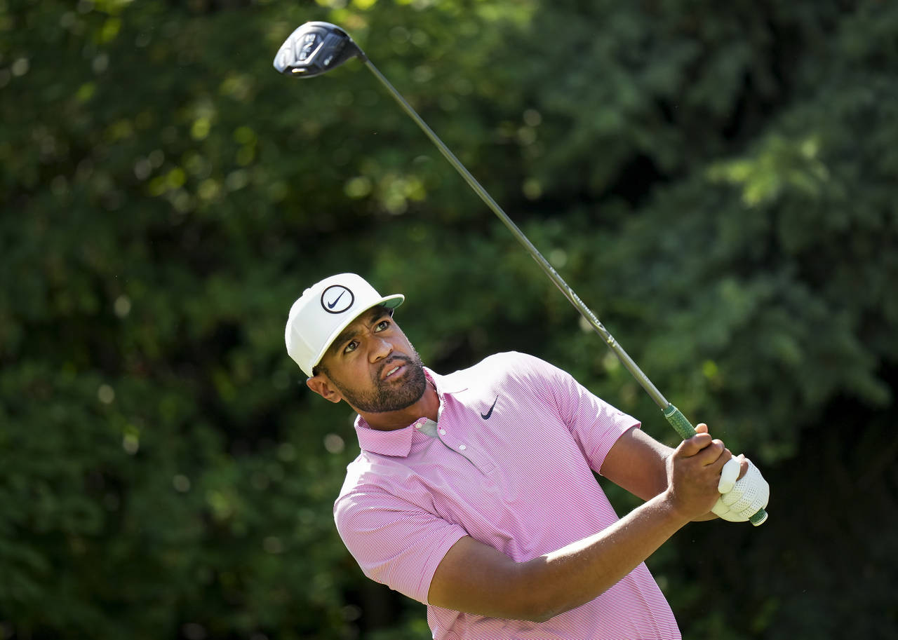 Tony Finau, of the United States, watches his tee shot on the 17th hole during round three of the C...