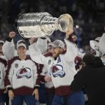 
              Colorado Avalanche center Nathan MacKinnon lifts the Stanley Cup after the team defeated the Tampa Bay Lightning in Game 6 of the NHL hockey Stanley Cup Finals on Sunday, June 26, 2022, in Tampa, Fla. (AP Photo/Phelan Ebenhack)
            