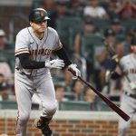 
              San Francisco Giants Wilmer Flores hits a 2-RBI single to take a 12-8 lead over the Atlanta Braves during the ninth inning of a baseball game on Tuesday, June 21, 2022, in Atlanta. (Curtis Compton Atlanta Journal-Constitution via AP)
            