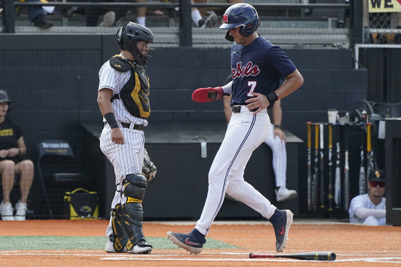 Southern Mississippi catcher Rodrigo Montenegro stands near the plate as Mississippi's Jacob Gonzal...