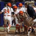
              Oklahoma State's Karli Petty (14) is met a home plate by teammates after her home run against Arizona during the sixth inning of an NCAA softball Women's College World Series game Thursday, June 2, 2022, in Oklahoma City. (AP Photo/Alonzo Adams)
            