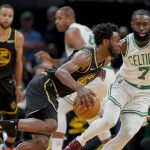 
              Golden State Warriors forward Andrew Wiggins (22) drives against Boston Celtics guard Jaylen Brown (7) during the first quarter of Game 3 of basketball's NBA Finals, Wednesday, June 8, 2022, in Boston. (AP Photo/Steven Senne)
            