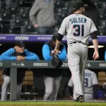 
              Miami Marlins relief pitcher Cole Sulser heads to the dugout after giving up a two-run home run to Colorado Rockies' Brendan Rodgers during the 10th inning of the second game of a baseball doubleheader Wednesday, June 1, 2022, in Denver. (AP Photo/David Zalubowski)
            