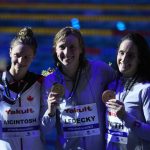 
              Katie Ledecky of United States, center, Summer Mcintosh of Canada, left, and Leah Smith of United States pose with their medals after the women's 400m freestyle final at the 19th FINA World Championships in Budapest, Hungary, Saturday, June 18, 2022. (AP Photo/Petr David Josek)
            