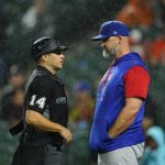 
              Home plate umpire Mark Wegner, left, talks with Chicago Cubs manager David Ross during the fourth/fifth inning of a baseball game against the Baltimore Orioles, Tuesday, June 7, 2022, in Baltimore. (AP Photo/Julio Cortez)
            