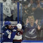 
              Tampa Bay Lightning left wing Pat Maroon (14) and Colorado Avalanche defenseman Josh Manson (42) scuffle during the second period of Game 3 of the NHL hockey Stanley Cup Final on Monday, June 20, 2022, in Tampa, Fla. (AP Photo/Chris O'Meara)
            