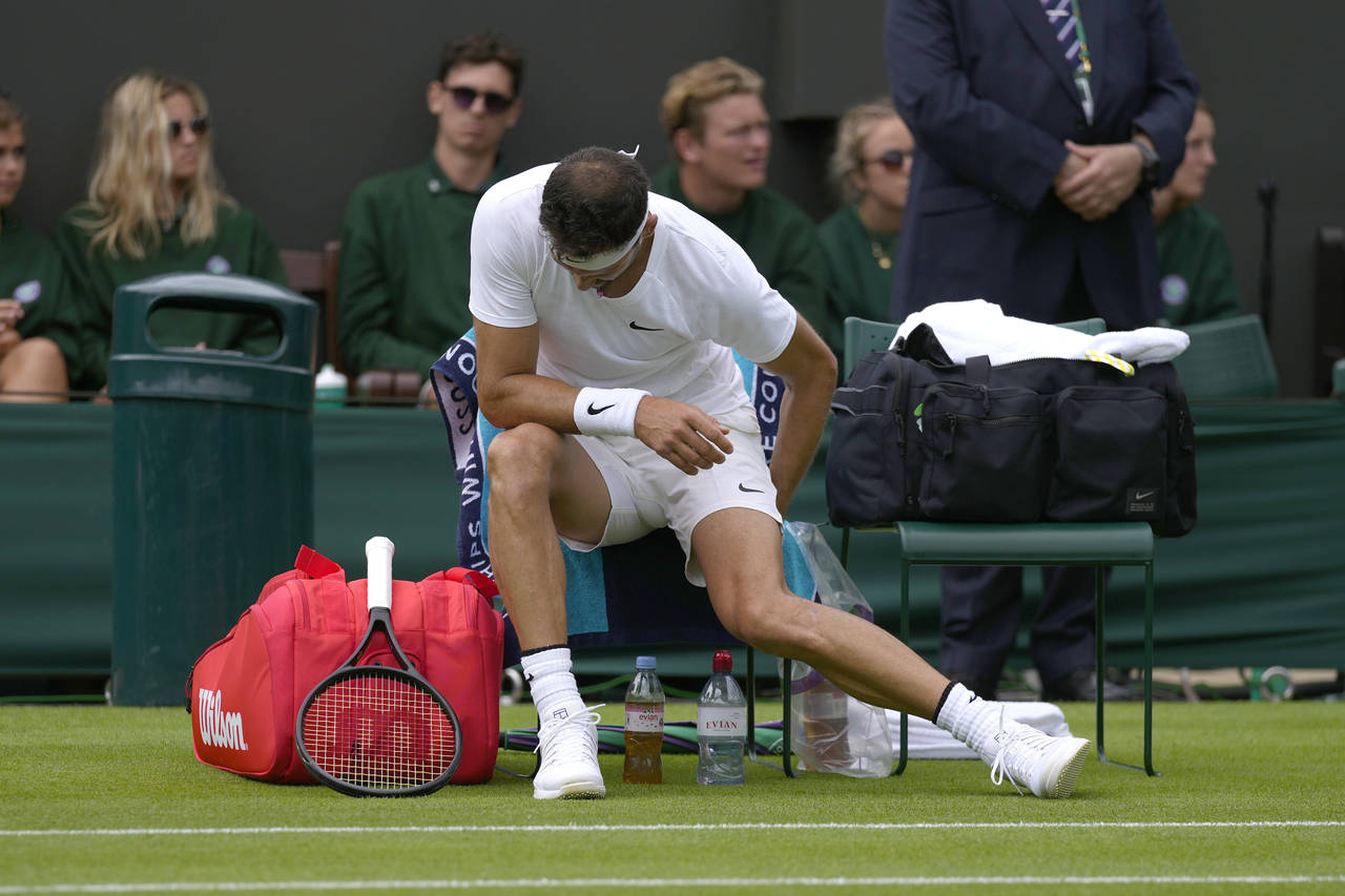 Bulgaria's Grigor Dimitrov sits down after an injury during the singles tennis match against Steve ...