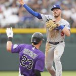 
              Los Angeles Dodgers second baseman Gavin Lux, right, throws over Colorado Rockies' Kris Bryant (23) after forcing Bryant out at second on the front end of a double play hit into by Brendan Rodgers during the third inning of a baseball game Monday, June 27, 2022, in Denver. (AP Photo/David Zalubowski)
            