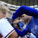 
              Los Angeles Dodgers first baseman Freddie Freeman (5) signs autographs for fans before the start of a baseball game against the Atlanta Braves Friday, June 24, 2022 in Atlanta. (AP Photo/Butch Dill)
            