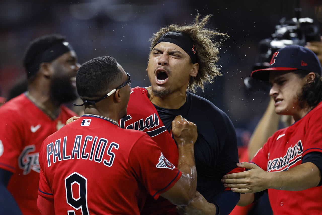 Cleveland Guardians' Josh Naylor, center, celebrates with Richie Palacios and Eli Morgan after hitt...