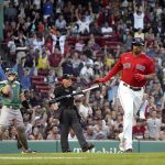 
              Boston Red Sox's Rafael Devers tosses his bat after hitting a two-run home run, as Oakland Athletics catcher Sean Murphy watches during the second inning of a baseball game at Fenway Park, Wednesday, June 15, 2022, in Boston. (AP Photo/Mary Schwalm)
            