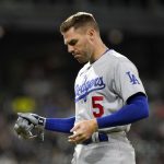 
              Los Angeles Dodgers' Freddie Freeman pulls off his batting gloves after flying out to end the top of the sixth inning of the team's baseball game against the Chicago White Sox on Tuesday, June 7, 2022, in Chicago. (AP Photo/Charles Rex Arbogast)
            