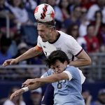 
              Uruguay forward Facundo Pellistri (8) and USA defender Walker Zimmerman, back, battle for the ball during the second half of an international friendly soccer match Sunday, June 5, 2022, in Kansas City, Kan. The match ended in a 0-0 tie. (AP Photo/Charlie Riedel)
            