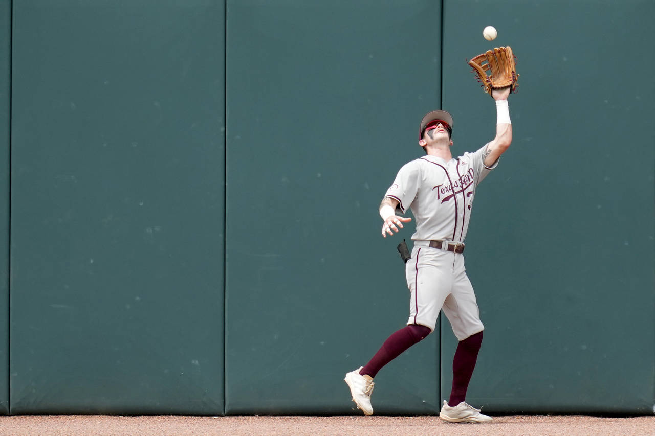 Texas A&M outfielder Jordan Thompson (31) catches a ball on the warning track for an out against Lo...