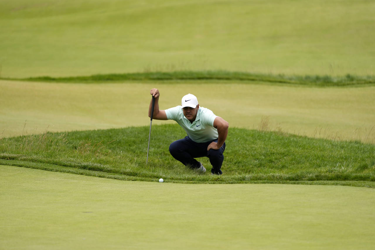 Brooks Koepka prepares to putt on the fourth hole during the third round of the U.S. Open golf tour...