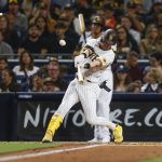 
              San Diego Padres' Jake Cronenworth hits a double against the Colorado Rockies during the fourth inning of the second game of a baseball doubleheader Saturday, June 11, 2022, in San Diego. (AP Photo/Mike McGinnis)
            