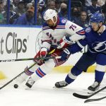 
              New York Rangers right wing Ryan Reaves (75) beats Tampa Bay Lightning defenseman Mikhail Sergachev (98) to a loose puck during the third period in Game 4 of the NHL hockey Stanley Cup playoffs Eastern Conference finals Tuesday, June 7, 2022, in Tampa, Fla. (AP Photo/Chris O'Meara)
            