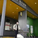 
              A man leaves Nishi-Koizumi train station painted green and yellow for the colors of the Brazilian flag, in Oizumi town, about 90 kilometers (55 miles) northwest of Tokyo, Tuesday, May 31, 2022. Of Oizumi's 40,000 residents, the local city hall says 20% were born outside Japan and just over half of those are Japanese Brazilians, among the largest concentrations in Japan. (AP Photo/Hiro Komae)
            