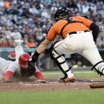 
              San Francisco Giants catcher Curt Casali, right, tags out Cincinnati Reds' Nick Senzel during the second inning of a baseball game in San Francisco, Friday, June 24, 2022. (AP Photo/John Hefti)
            