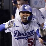
              Los Angeles Dodgers' Mookie Betts celebrates in the dugout after hitting a solo home run during the eighth inning of a baseball game against the Los Angeles Angels Tuesday, June 14, 2022, in Los Angeles. (AP Photo/Mark J. Terrill)
            