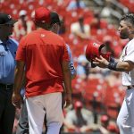
              St. Louis Cardinals' Yadier Molina, right, pleads his case with umpires Scott Barry, Dan Iassogna after being called at second base during the fourth inning in the first game of a baseball doubleheader, Tuesday, June 14, 2022, in St. Louis. (AP Photo/Scott Kane)
            