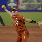 
              Texas' Hailey Dolcini (27) pitches in the fifth inning of the second game of the NCAA Women's College World Series softball championship series against Oklahoma on Thursday, June 9, 2022, in Oklahoma City. (AP Photo/Sue Ogrocki)
            