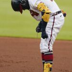 
              Atlanta Braves' Ronald Acuna Jr. (13) tries to repair his chain after it broke as he ran to first base on a single during the first inning of the team's baseball game against the Oakland Athletics on Wednesday, June 8, 2022, in Atlanta. (AP Photo/John Bazemore)
            