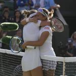 
              Belgium's Kirsten Flipkens hugs Romania's Simona Halep at the end of their second round women's single match on day four of the Wimbledon tennis championships in London, Thursday, June 30, 2022. (AP Photo/Alastair Grant)
            