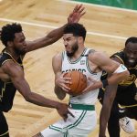 
              Boston Celtics forward Jayson Tatum (0) drives against Golden State Warriors forward Andrew Wiggins, left, and forward Draymond Green (23) during the second quarter of Game 4 of basketball's NBA Finals, Friday, June 10, 2022, in Boston. (AP Photo/Michael Dwyer)
            