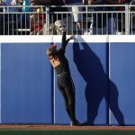 
              Oregon State outfielder Eliana Gottlieb (12) reaches for a Florida home run during the fifth inning of an NCAA softball Women's College World Series game Thursday, June 2, 2022, in Oklahoma City. (AP Photo/Alonzo Adams)
            