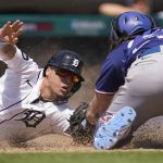 
              Detroit Tigers' Javier Baez slides safely to score ahead of the tag of Texas Rangers catcher Jonah Heim at home plate in the fifth inning of a baseball game in Detroit, Sunday, June 19, 2022. (AP Photo/Paul Sancya)
            